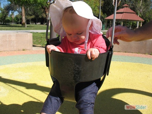 a baby sitting in the swing
